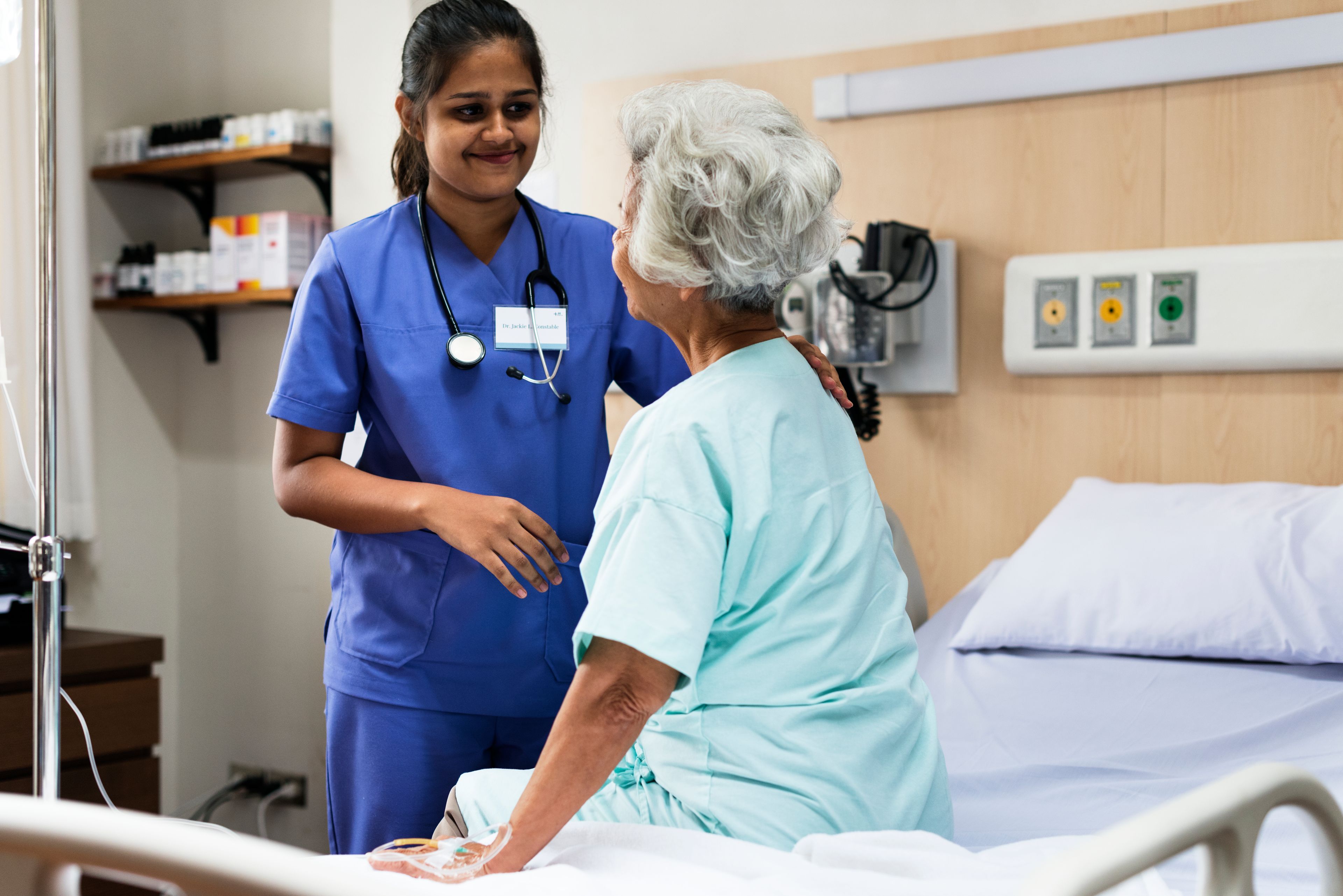 Caring nurse with elderly patient